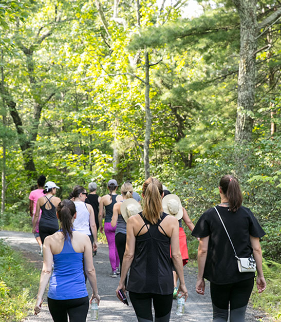 group of women walk on trail